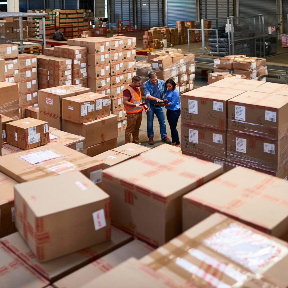 Shot of people at work in a large warehouse full of boxes